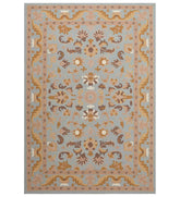Light blue and beige traditional rug with floral medallion design.